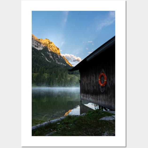 Boathouse with lifesaver Portrait. Amazing shot of a wooden house in the Ferchensee lake in Bavaria, Germany, in front of a mountain belonging to the Alps. Scenic foggy morning scenery at sunrise. Wall Art by EviRadauscher